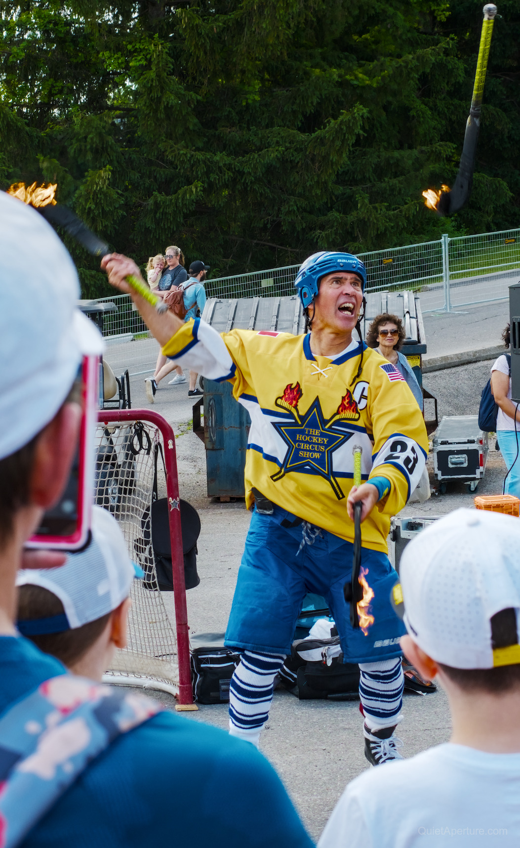 A hockey circus performer juggling flaming sticks at the Bread & Honey Festival, frame 02.